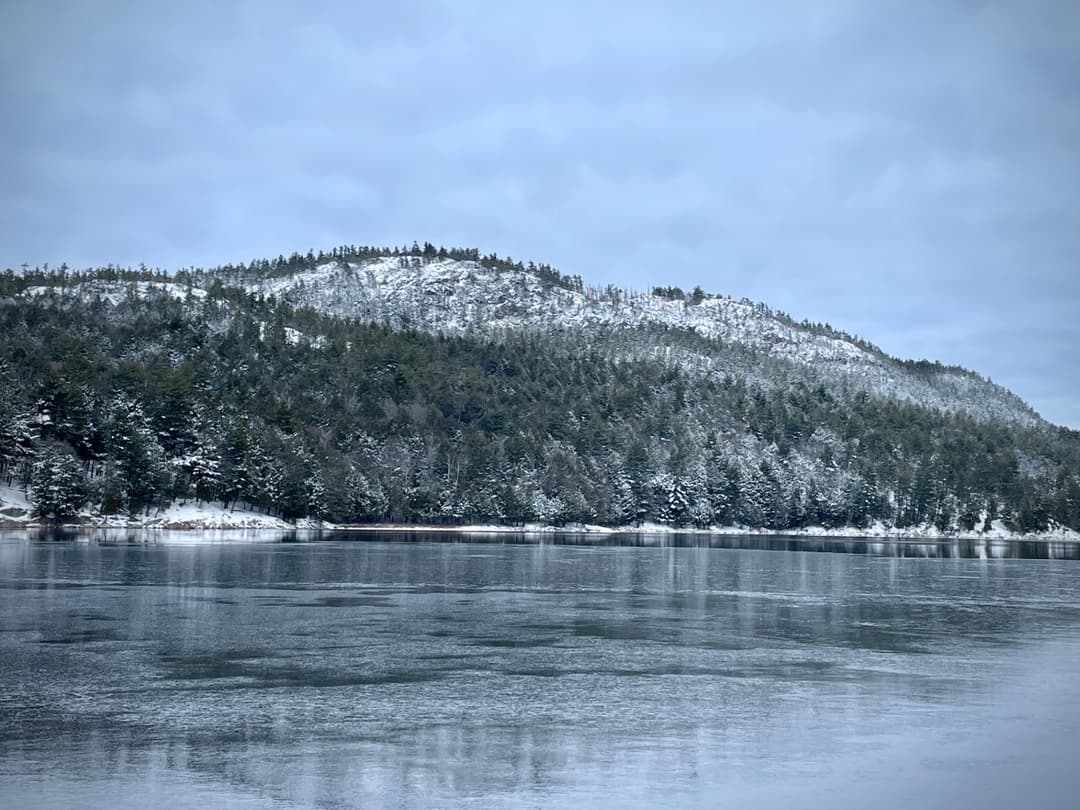 Mountain next to frozen lake