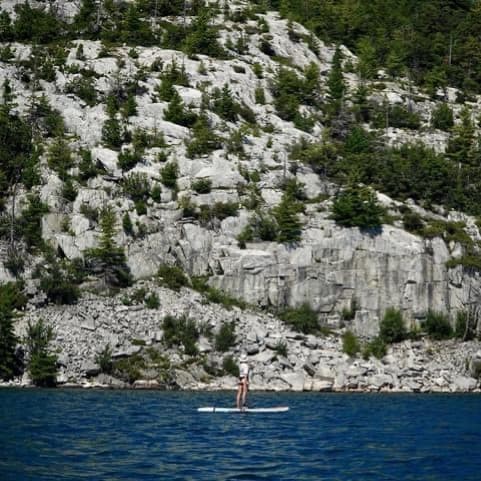Person paddleboarding on the water